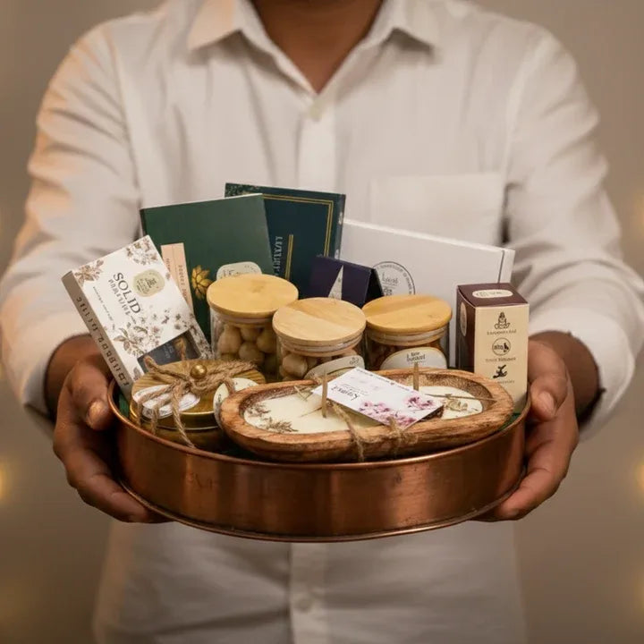 Diwali gift hamper with multiple candles arranged in a tray