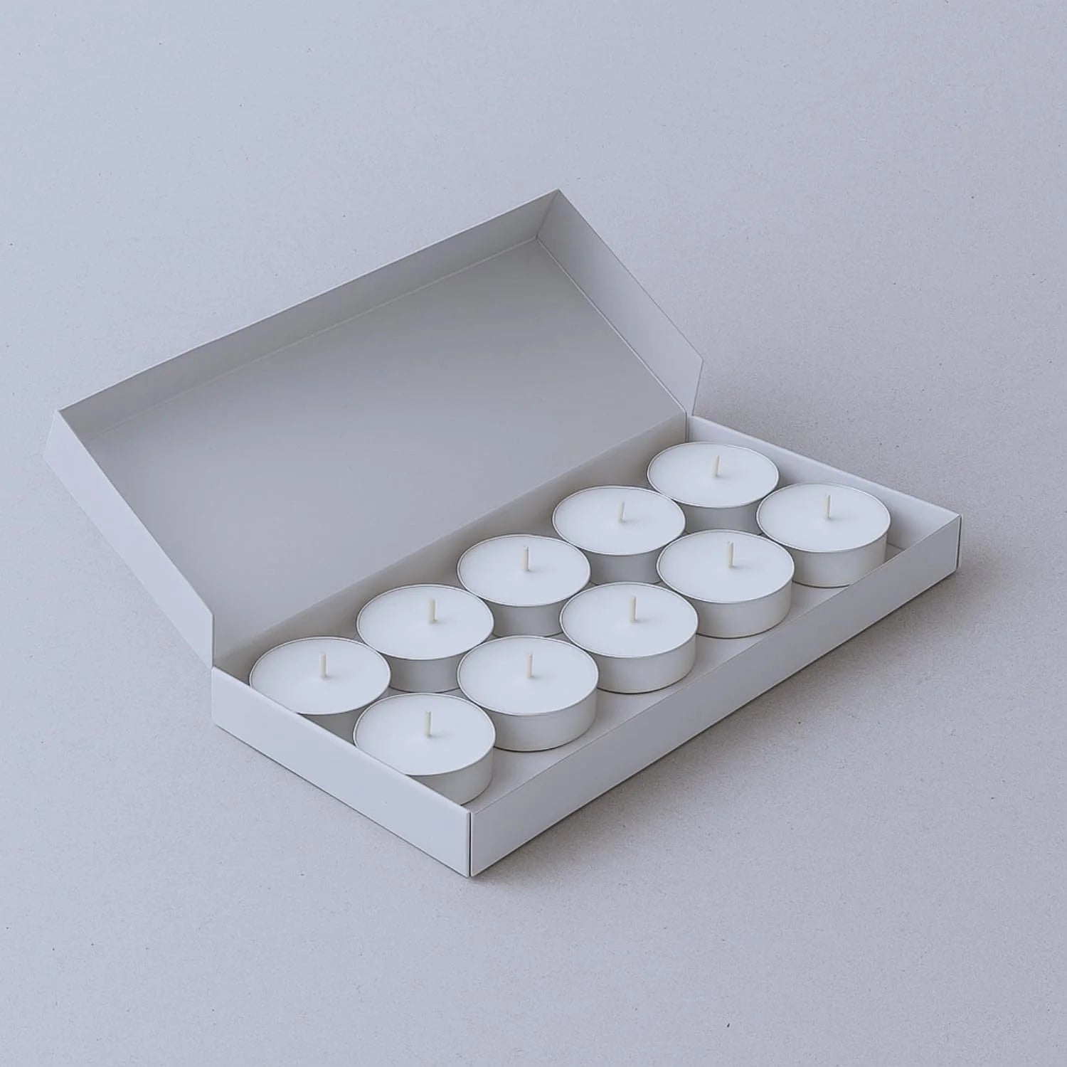 Basil fragrance tea light candles open packaging box showing candle arrangement