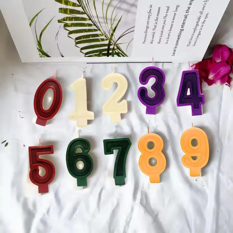 Colorful birthday number candles from 0 to 9 arranged on a soft background