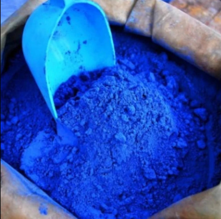 Blue pigment powder in container for candle dye and wax mixing