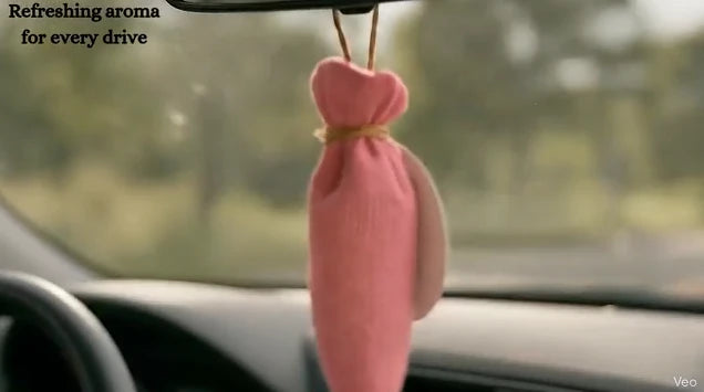 Camphor air freshener cone placed inside car interior product usage image