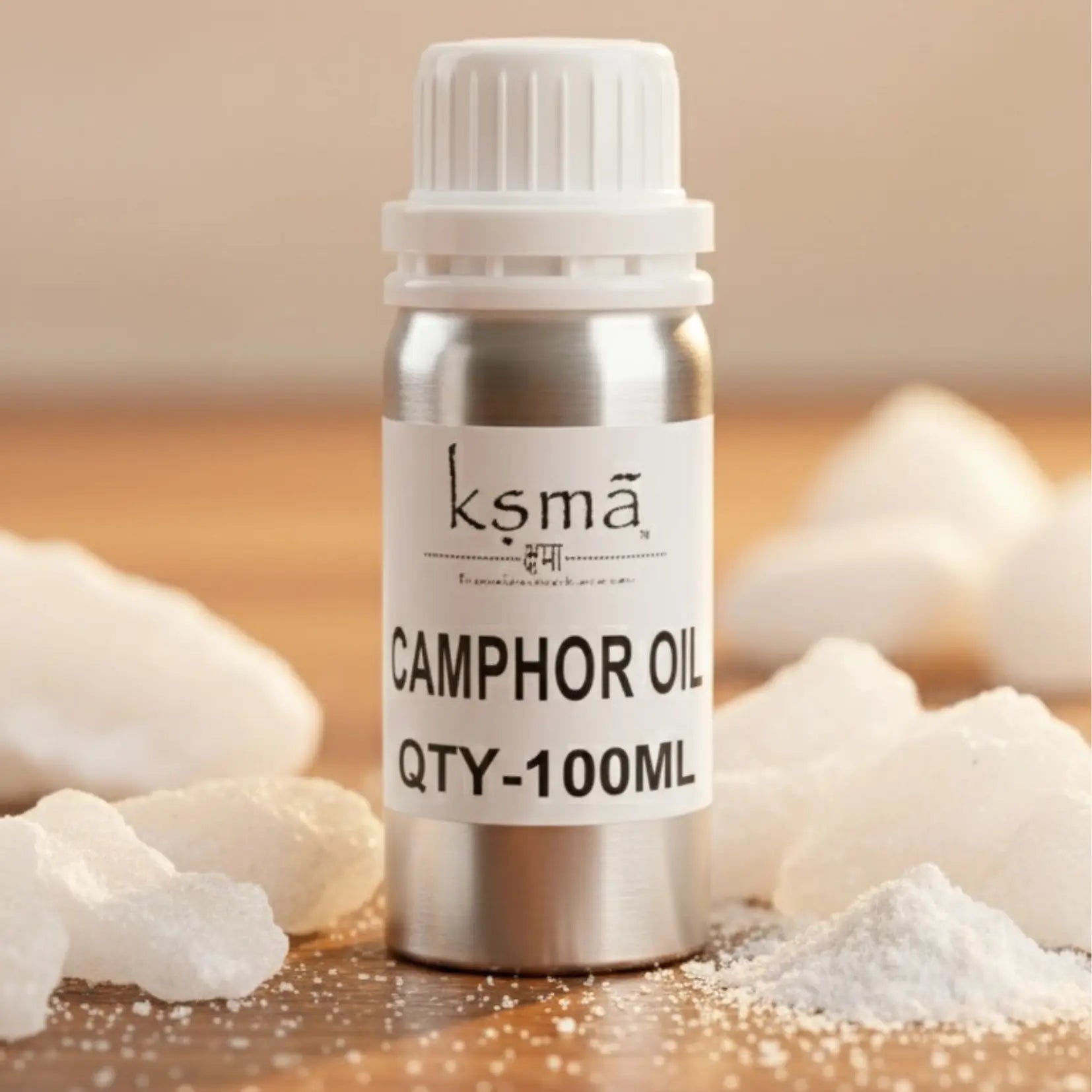 Camphor oil white bottle placed with camphor crystals