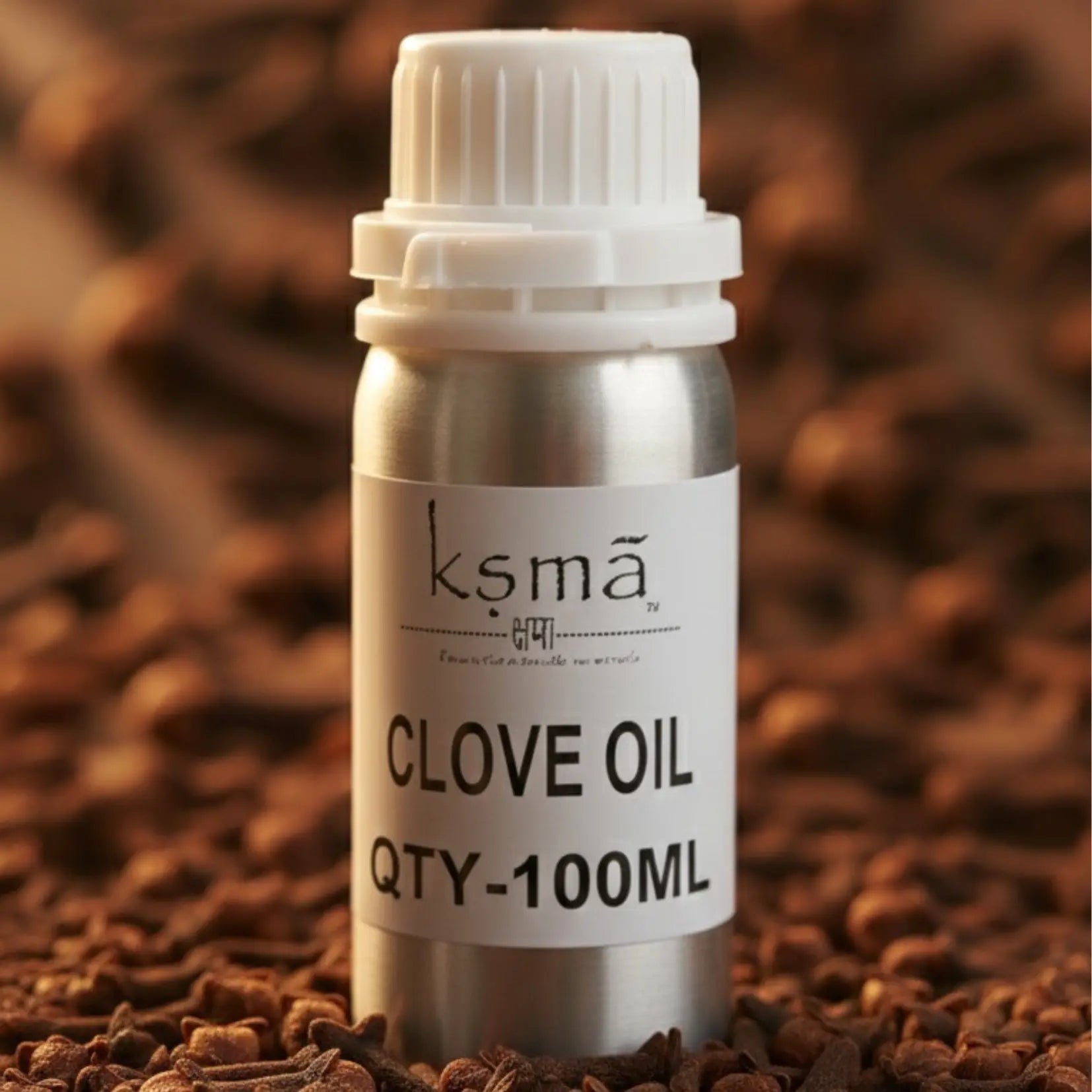Clove oil in white bottle placed with clove pieces background