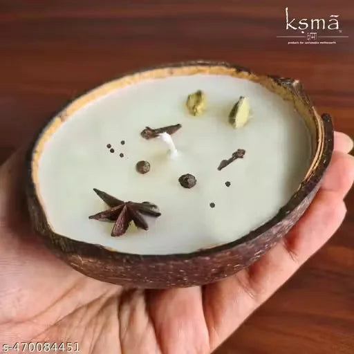 Coconut shell candle placed with flowers in decorative setup
