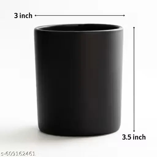Coffee bean scented candle in black jar on clean minimal background