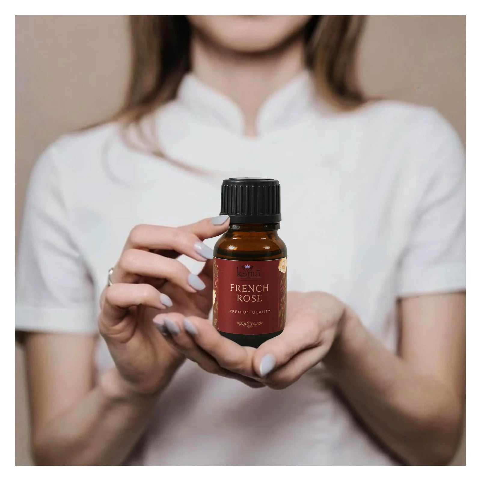 Person holding french rose fragrance oil bottle for daily use and application