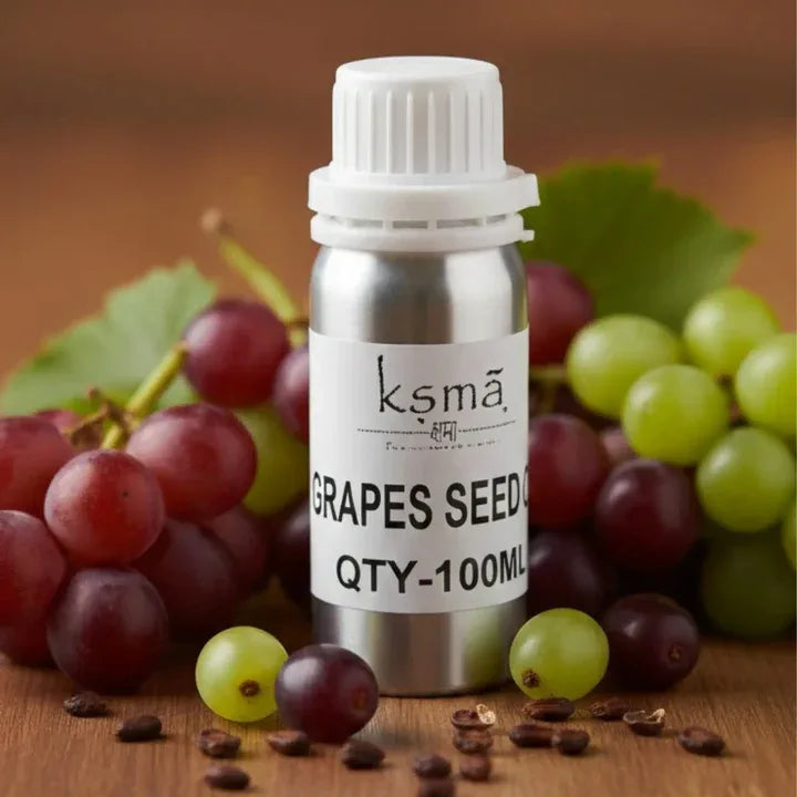 Grapeseed carrier oil bottle placed with fresh grapes in background