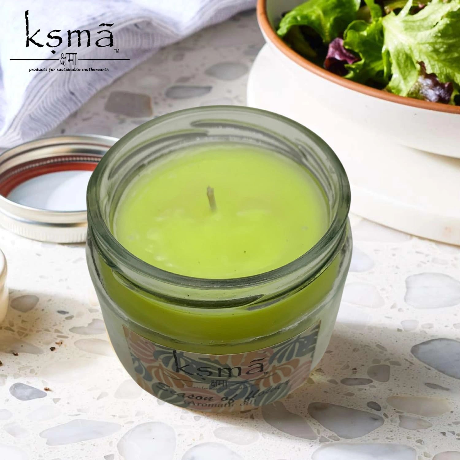 Decorative jar candle placed on table enhancing cozy home ambiance