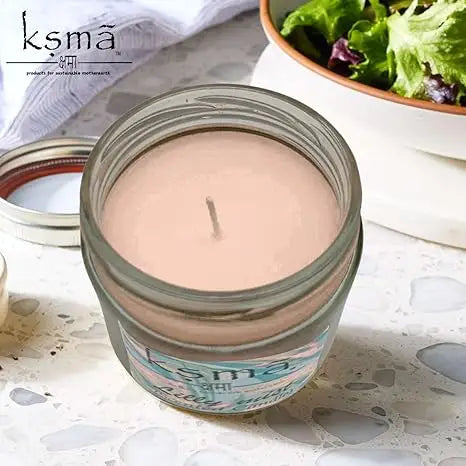Top view of Lilly Mist candle showing smooth wax surface inside glass jar