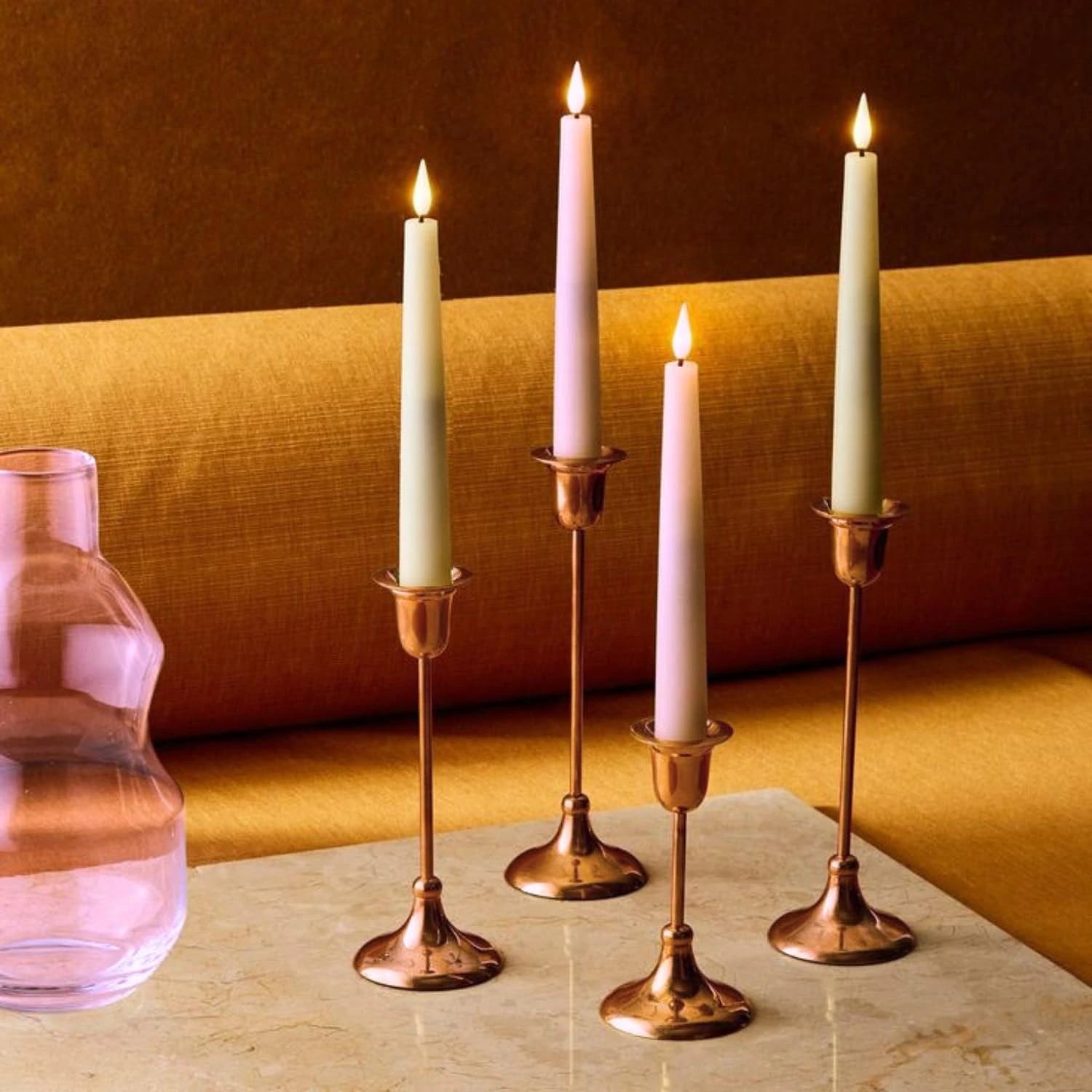 Long pillar candles lit to create warm ambiance for home and special occasions