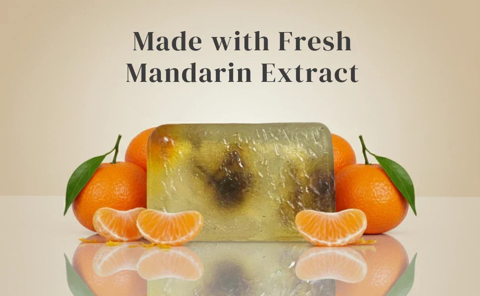 Handcrafted soap with mandarin slices and ingredient display setup