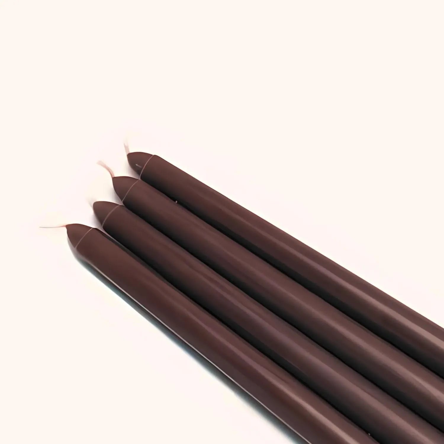 Bundle of mocha pillar candles showing smooth texture and uniform design
