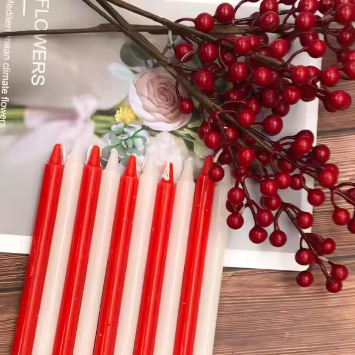 Multi color taper candles arranged with decorative elements for festive home decor and table styling