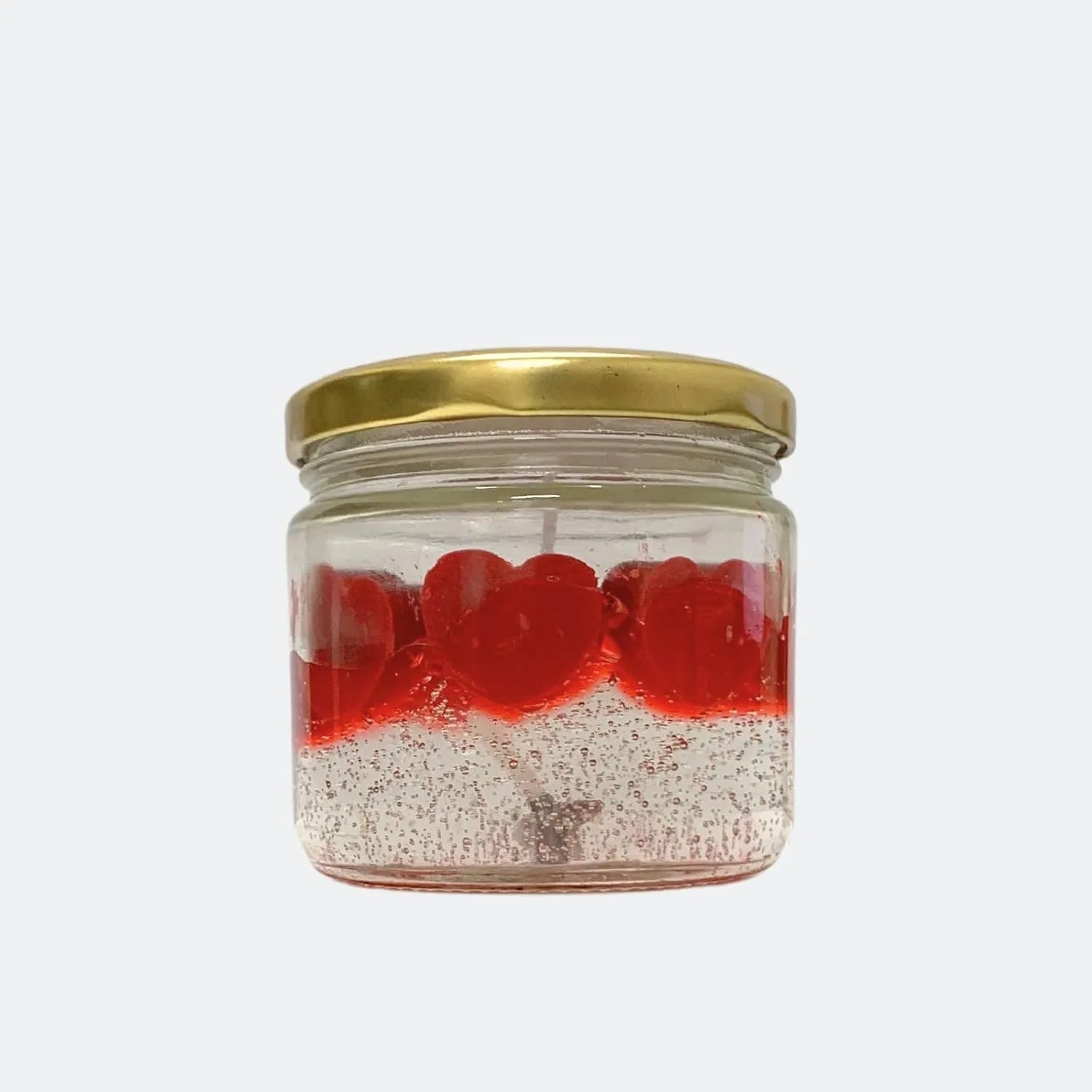 glass jar candle with red heart design placed in modern decor setup