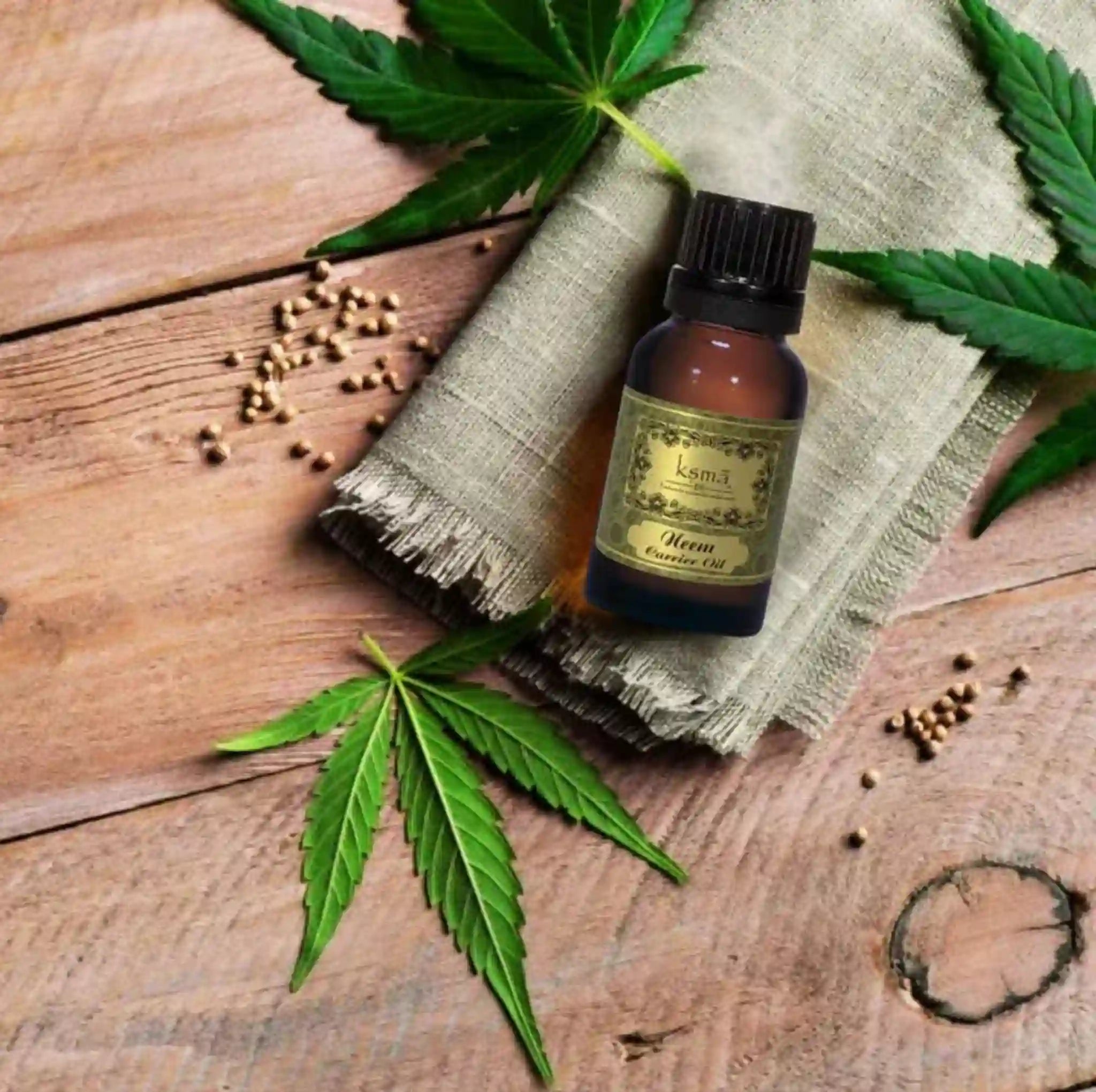 Neem carrier oil bottle with neem leaves on wooden surface