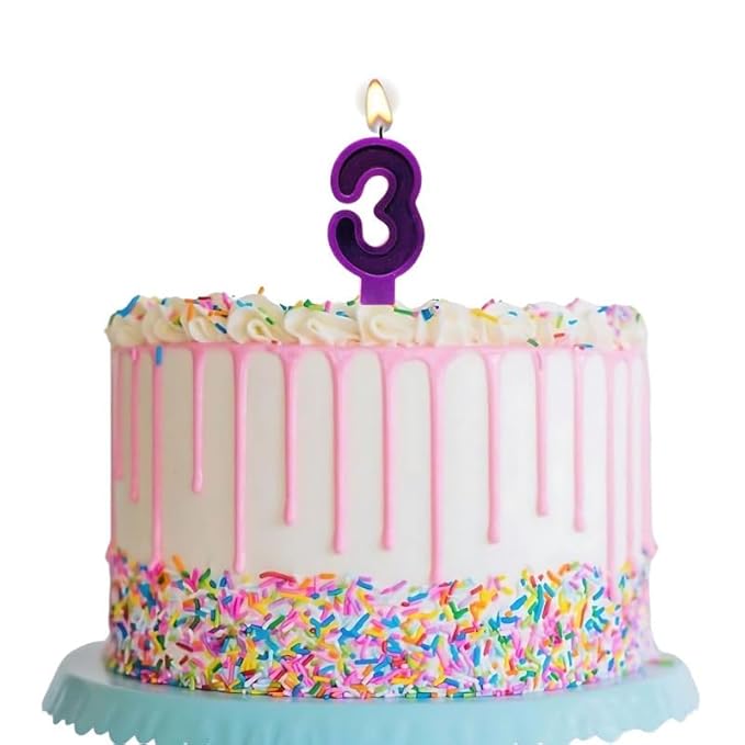 Number 3 birthday candle placed on decorated birthday cake