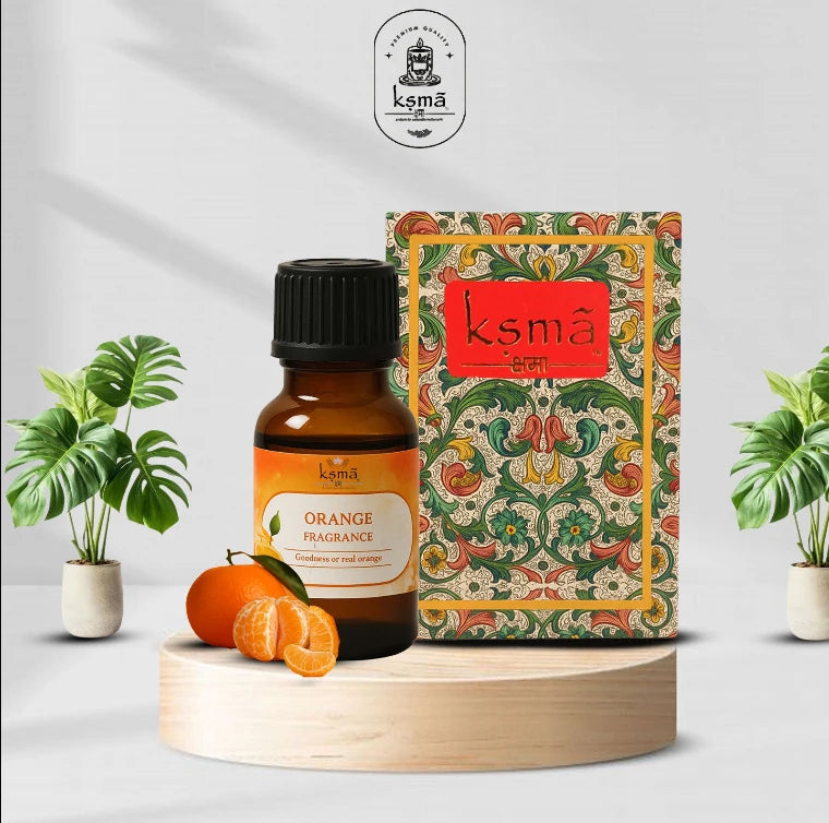 Orange fragrance oil bottle with packaging box and sliced oranges on display setup