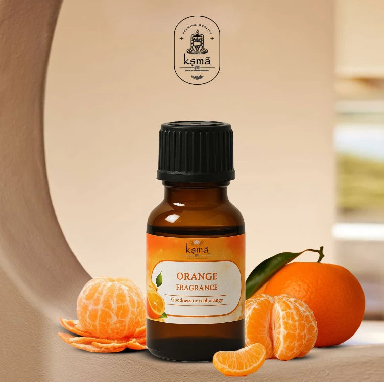Orange fragrance oil bottle placed with whole and sliced oranges on clean background
