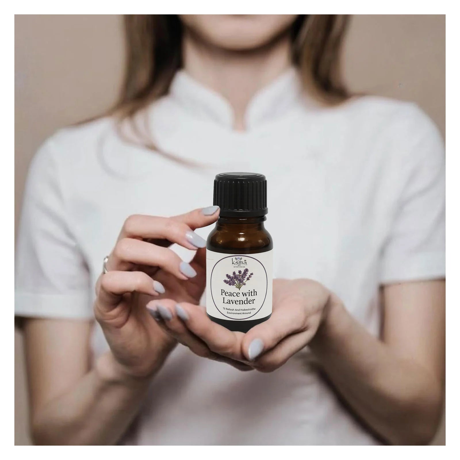 Person holding lavender fragrance oil bottle for daily use