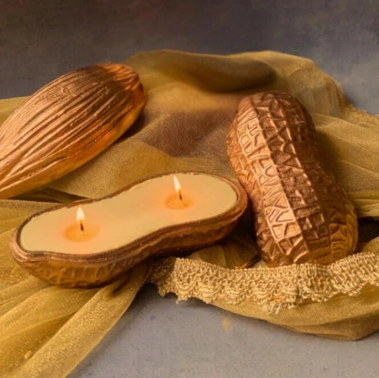 Peanut pod shape decorative candles placed on wooden surface