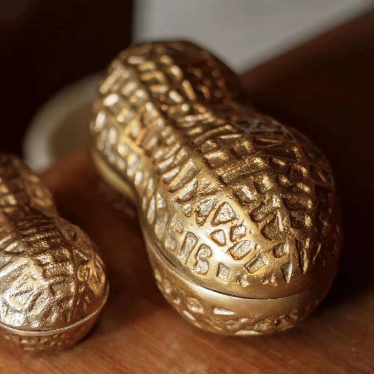 Decorative peanut pod shaped candle with detailed metal case design