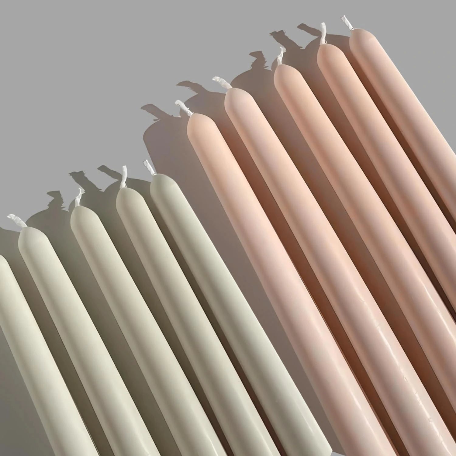 Close up view of pearl white long pillar candles showing smooth finish and design
