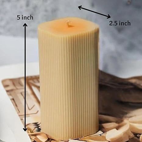 Decorative pillar candle close up showing wax texture and flame