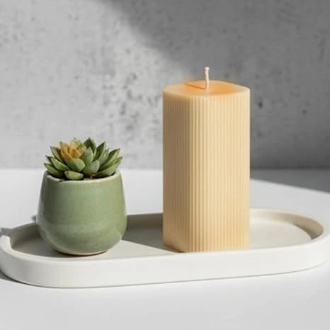 French vanilla pillar candle placed on tray in styled home setup