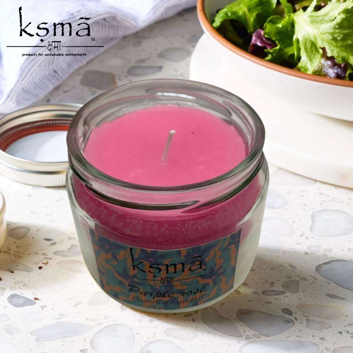 Angled view of purple rose jar candle highlighting wax texture and elegant glass design