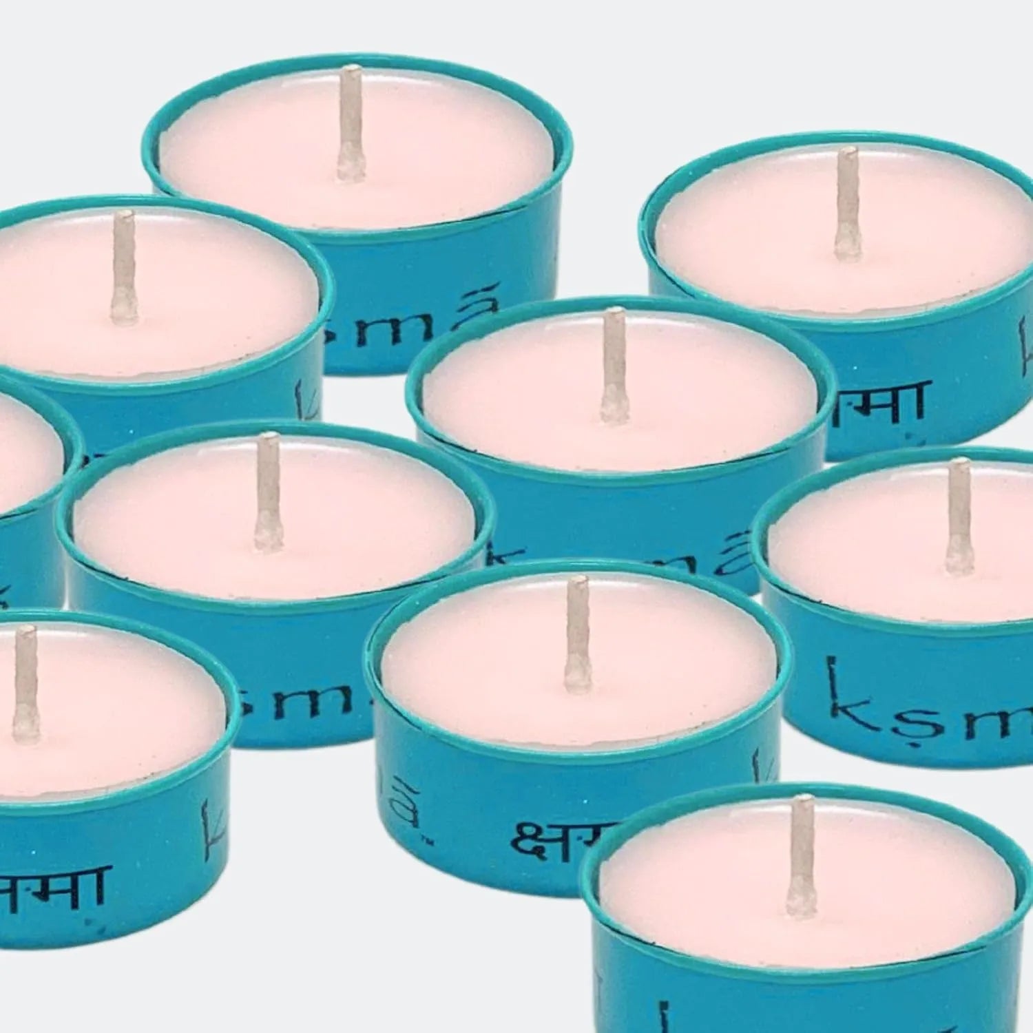 Top view of multiple tealight candles arranged in a neat pattern