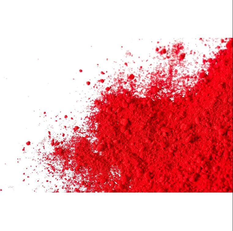 Red pigment powder spread showing fine texture for candle making