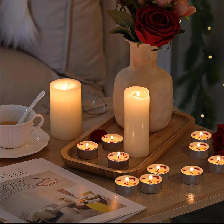 Rose tealight candles placed on dining table with warm lighting and decorative setup