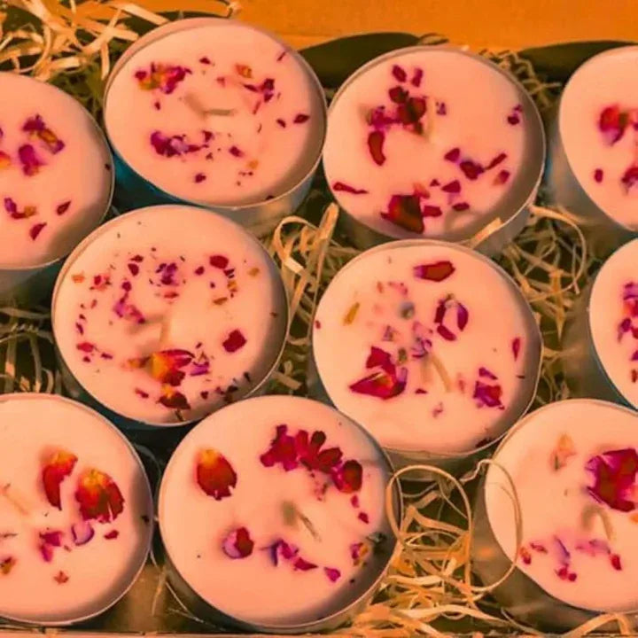 close up glowing rose tealight candles warm ambient lighting festive decor