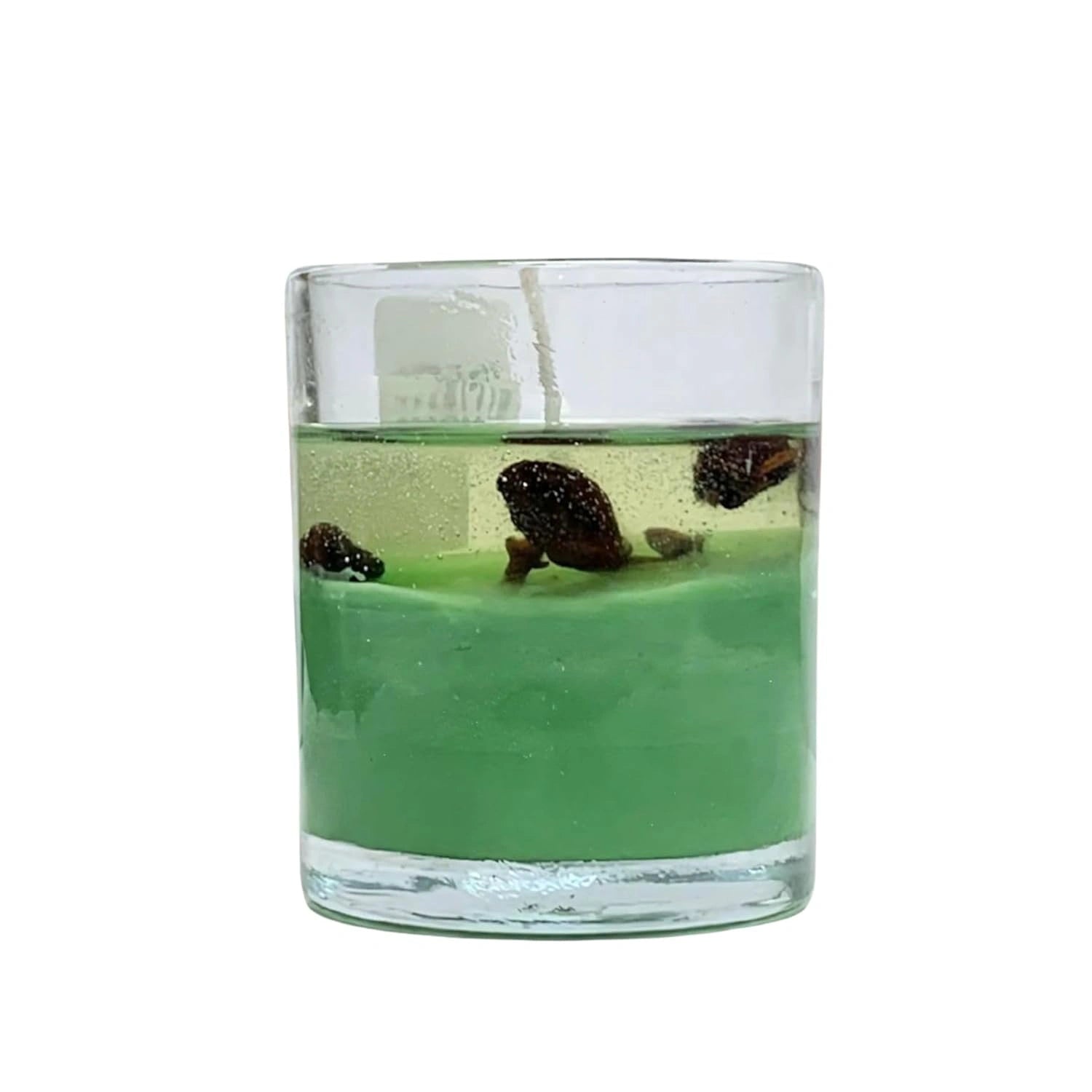 Close view of sea green kaadha candle showing herbal ingredients in glass container