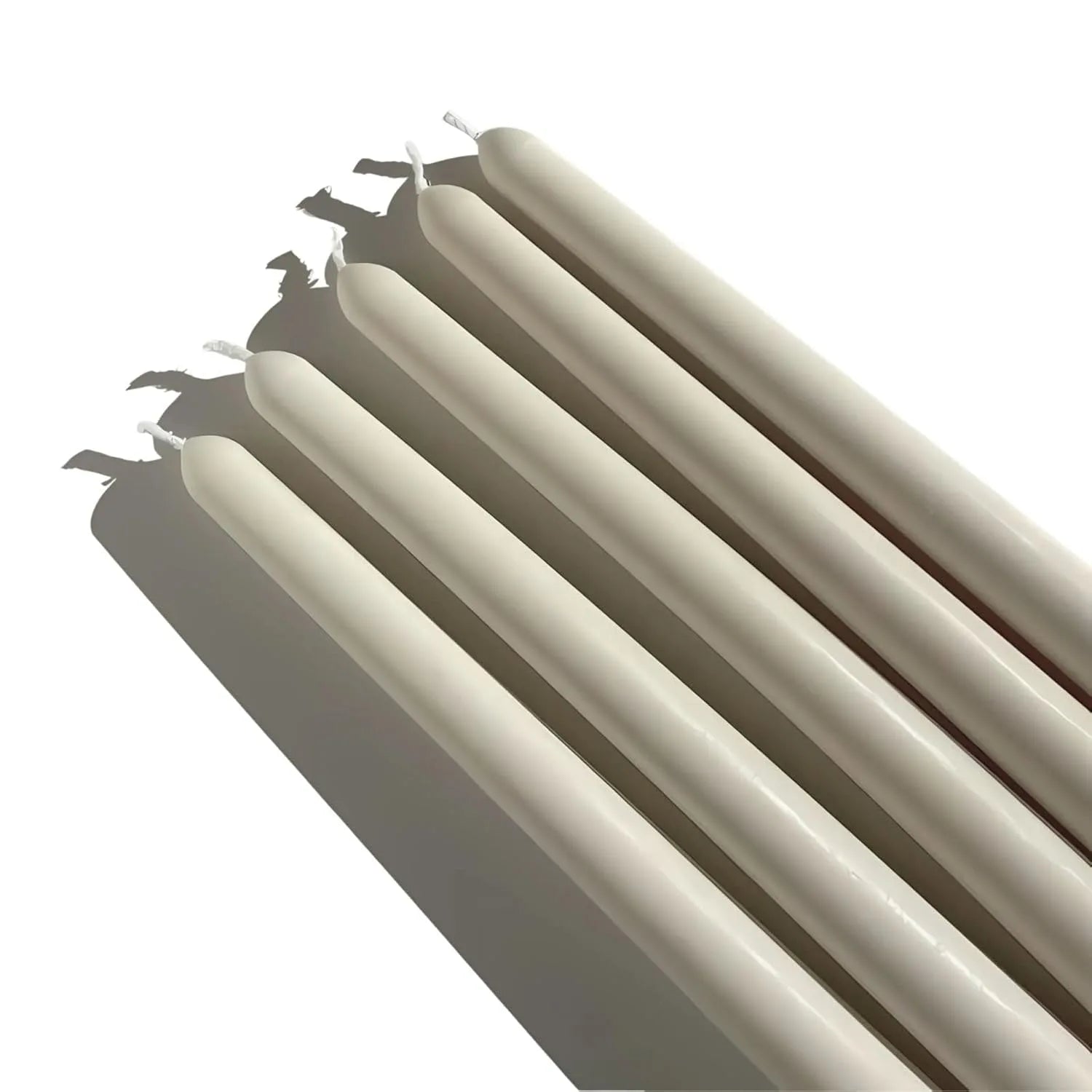 Set of four long pillar candles in pearl white color arranged together for home decor