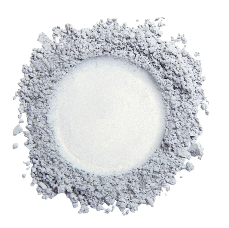 Top view of silver pigment powder spread in circular pattern for candle coloring use