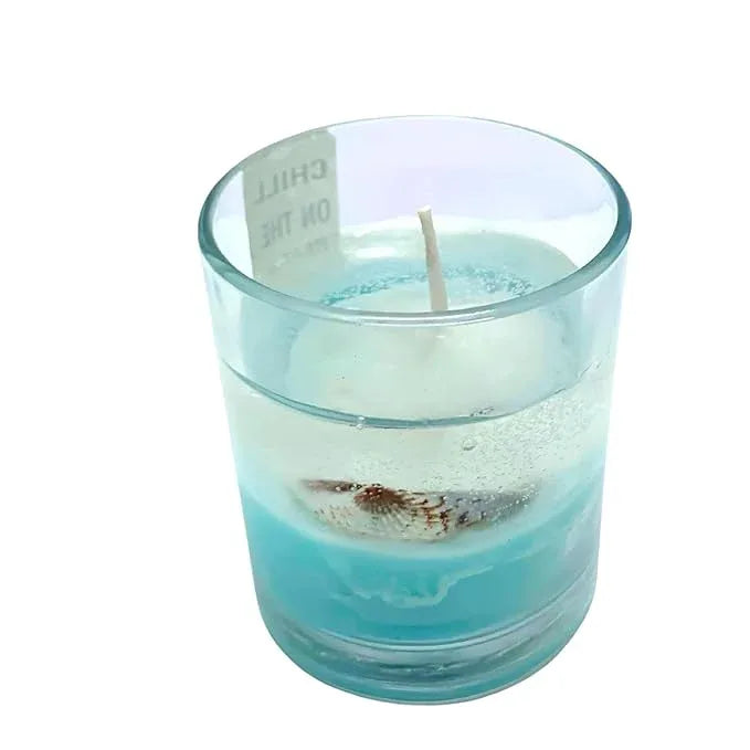 Blue gel candle with beach sand design inside glass jar