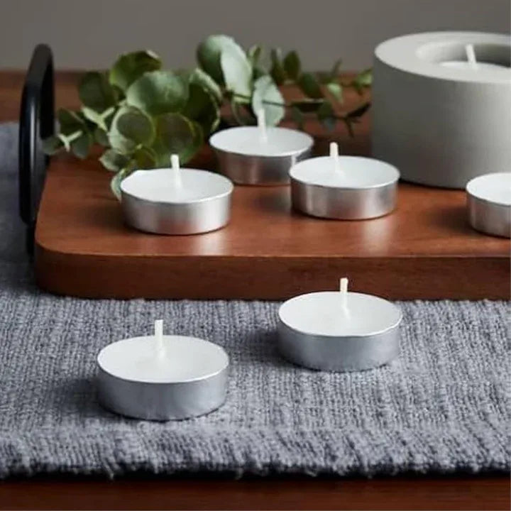 Tealight candles placed on decorative tray with lit candle display