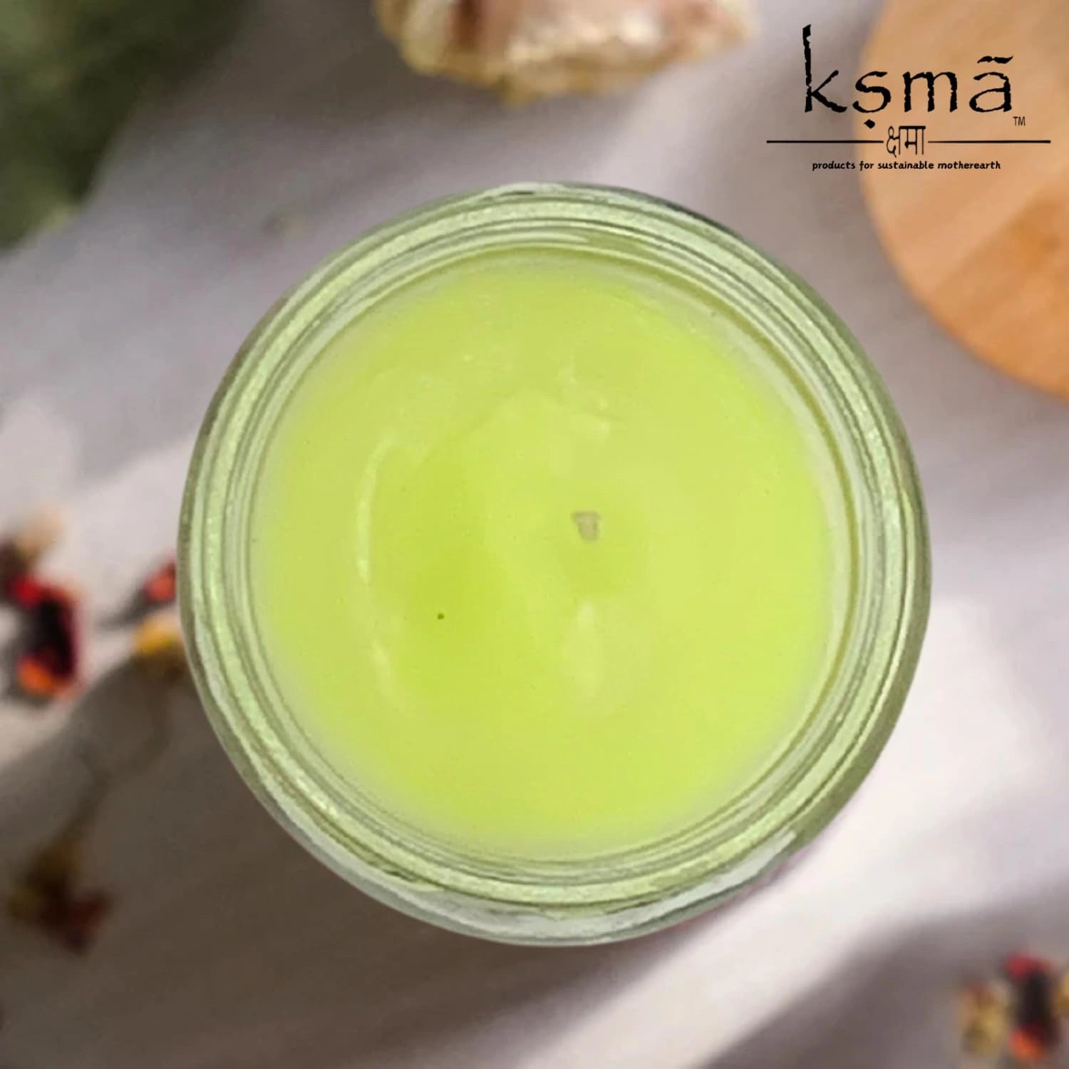 Top view of green wax jar candle showing smooth surface and clean finish