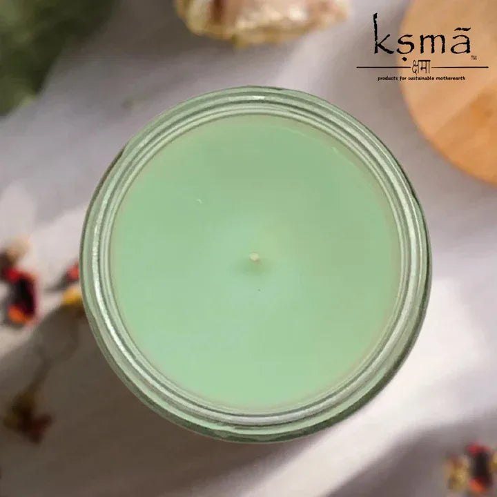 Top view of green wax jar candle with smooth surface and calming appearance