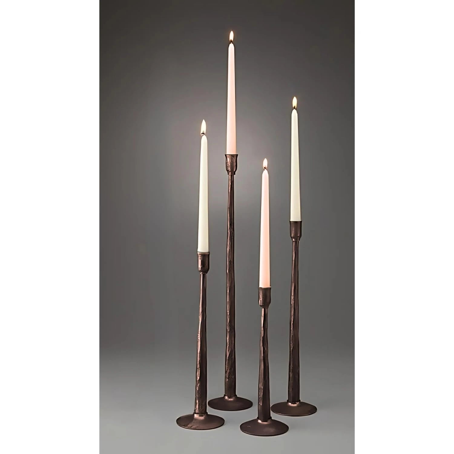 Set of four vanilla amber pillar candles placed in a metal stand for elegant home decor